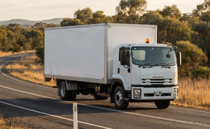 Class 5 dangerous goods NSW: Australian cab-over truck carrying packaged oxidising substances on a plain regional road
